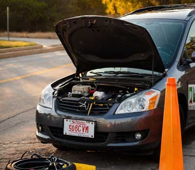 Good Sam roadside assistance helping a vehicle owner during a roadside emergency